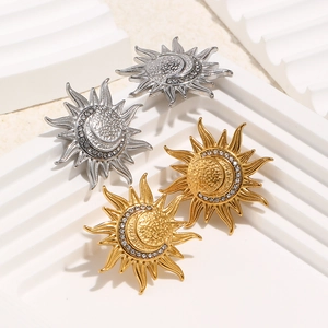 Detailed close-up of 18K gold and silver sun moon earrings with crystal accents