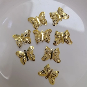 Detailed macro view of 14K gold butterfly hollow charms for jewelry making DIY