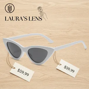 Retro white cat-eye sunglasses with dark grey lenses in a 45-degree profile view
