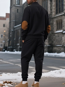 Rear view of men's black knit tracksuit featuring stylish brown elbow patch detailing