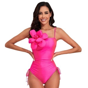 Hot pink one-piece swimsuit for women with a 3D floral accent and side drawstring ties