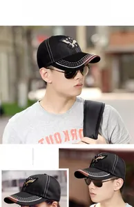 Detail of black baseball cap with eagle embroidery and white contrast stitching detail