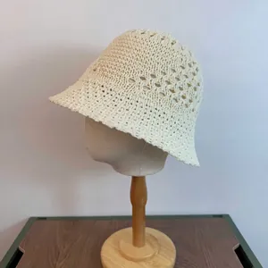 Detail of cream hollow knit bucket hat with diamond crochet patterns on mannequin head