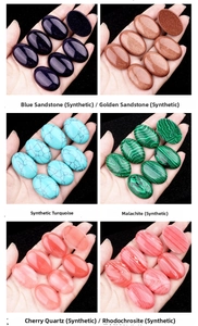 Macro detail of oval synthetic gemstone cabochons including malachite and sandstone