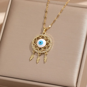 Detail of evil eye dreamcatcher necklace with feathers on champagne silk box