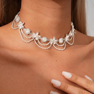 Close-up of elegant floral necklace with shimmering crystal petals and double layer tassels