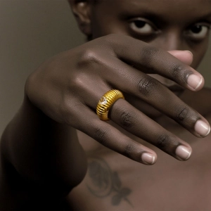 Close-up of 18K gold plated heart zircon ring with textured band on a hand