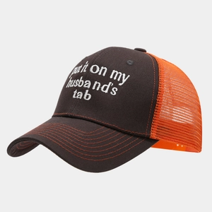 Detail of truck hat with white embroidery and bright orange breathable mesh back