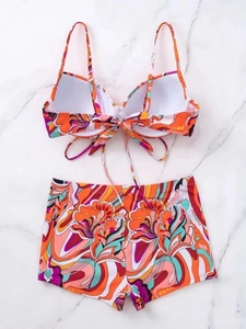 Detail of two-piece floral graffiti swimsuit with padded halter top and boyshort bottoms