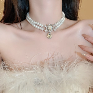 Double-layer pearl necklace with rhinestone flower and teardrop pendant on neck