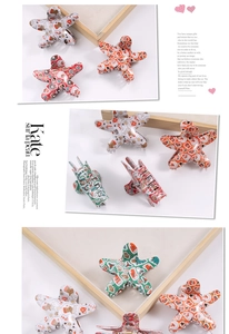 Detailed view of star-shaped Christmas claw clips with reindeer and snowman patterns
