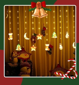 Detail view of warm LED Christmas curtain lights with stars and holiday hanging charms