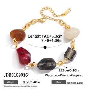 Detail view of colorful resin beads and golden stainless steel chain bracelet with specs