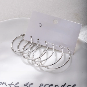 Set of six silver hoop earrings in various sizes displayed on a fashion jewelry card