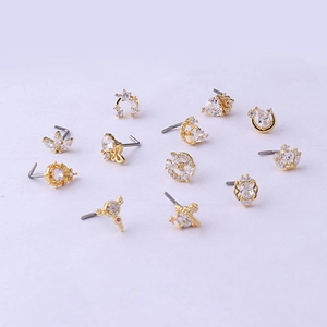 Set of 12 gold titanium 20G nose studs with zirconia butterfly, moon, and crown designs