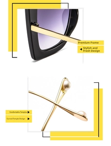 Detail of square sunglasses with gold metal temples and beige pearl decoration at tips