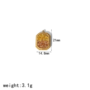 Detail of rectangular gold pendant with yellow and orange crystals showing 21mm height
