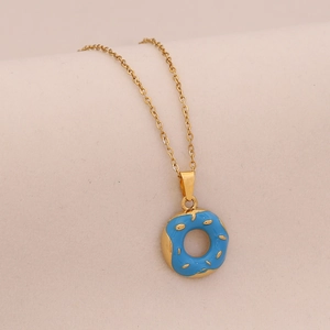 Minimalist gold stainless steel necklace featuring a blue donut charm with sugar sprinkles