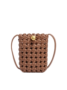 Brown woven bucket crossbody bag with a round gold metallic buckle on white background