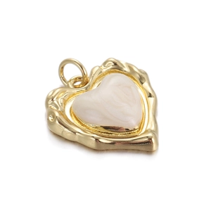 Detailed macro shot of a gold wavy heart pendant with a white pearlescent center