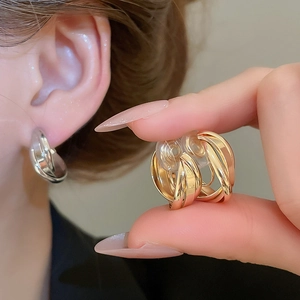 Minimalist twisted multilayer hoop clip earrings in polished gold and silver metal finishes