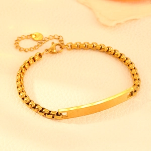 Polished gold stainless steel rectangular bar bracelet with round links on beige background