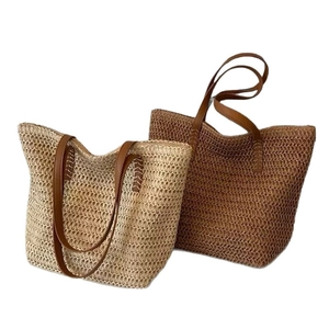 Minimalist summer straw woven tote bag with brown leather straps for beach holidays