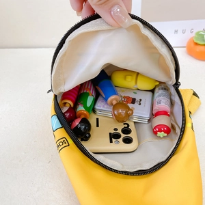 Interior view of yellow kids chest bag showing large capacity for toys and daily items