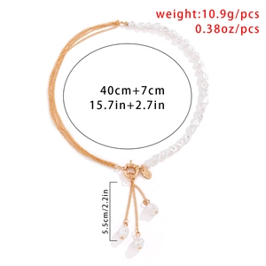 Detail of layered gold chains with baroque pearls and tassel fringe pendant necklace