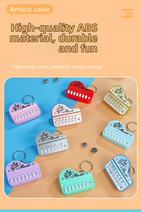 Macro shot of colorful mini piano keychains showing keys and button batteries