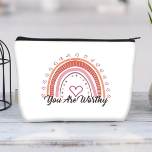 Detail of white canvas pouch featuring a rainbow design and You Are Worthy text