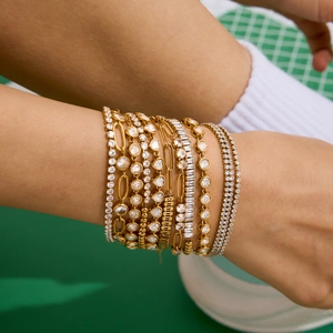Layered 18K gold plated stainless steel bracelets with white zircon stones on wrist