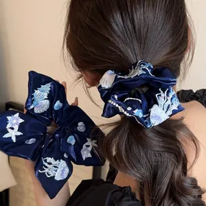 Navy blue velvet scrunchie with detailed sea shell and jellyfish embroidery