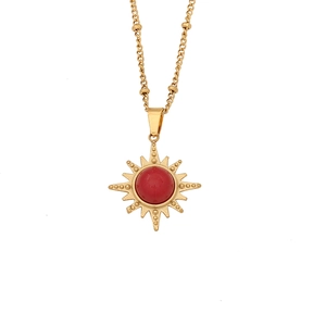Vintage golden beaded necklace featuring a sun pendant with a red gemstone center
