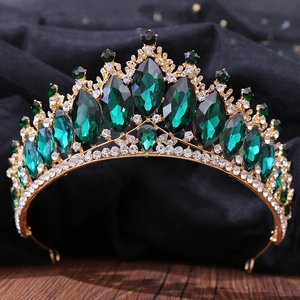 Macro detail of Baroque gold tiara featuring emerald green crystals and clear rhinestones
