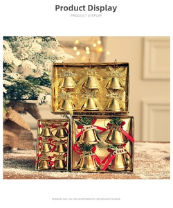 Close-up of golden Christmas bells with glitter bows and Merry Christmas lettering