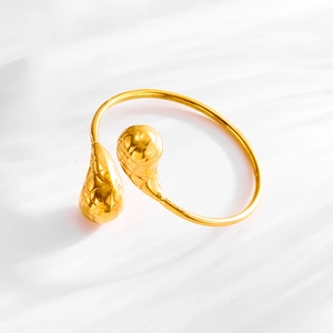 Detailed close-up of 18K gold-plated stainless steel cuff with unique teardrop texture
