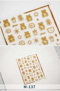Detailed view of 3D gold-embossed bear and floral nail stickers on sheet M-137