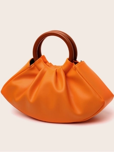 Chic orange pleated dumpling handbag with brown round top handles on pink background