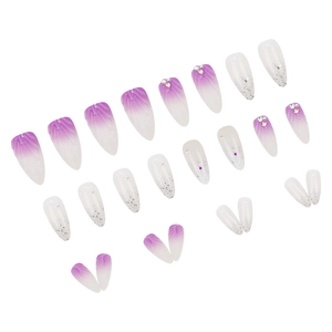 Long stiletto press-on nails set with purple gradient design, pearls, and rhinestones