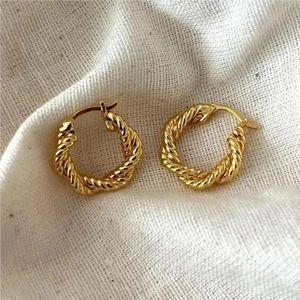 Detailed view of gold twisted rope hoop earrings featuring S925 sterling silver hallmark