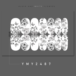 Close-up of black and white flower nail stickers with butterfly patterns for DIY manicure
