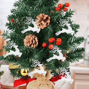 Close-up of white glitter reindeer ornaments hanging on a Christmas tree with pine cones