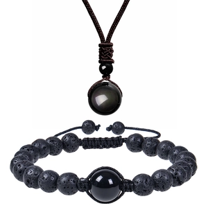 Detailed set featuring braided black lava stone bracelet and polished gemstone necklace