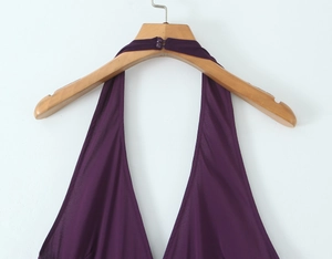 Detail of elegant deep purple halter dress featuring V-neckline and back button closure