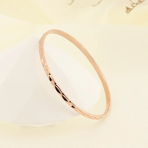 Detail shot of rose gold titanium steel bracelet with faceted diamond-cut texture