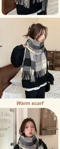 Detailed view of the thick checkered scarf with classic fringe and soft woven texture