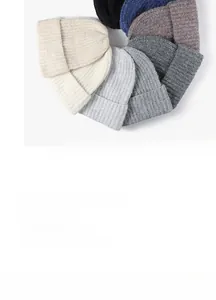 Detailed overhead view of ribbed knit beanies in various neutral colors and textures