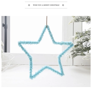 Detail view of a soft light blue plush star ornament hanging for Christmas tree decoration
