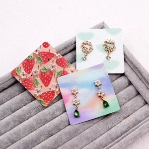 Floral stud and teardrop earring set displayed on premium 400g jewelry display cards